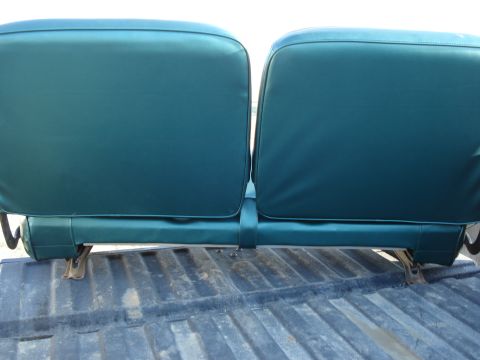 1979 Ford F-150 - The rear of two teal bench seats is visible, mounted above a truck bed.