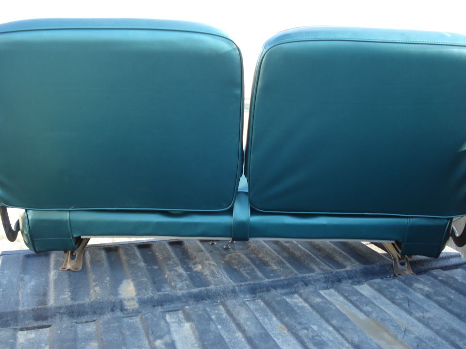 Back of two teal bench seats in a truck bed
