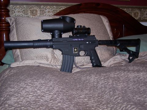 1986 Ford Bronco - A tactical-style paintball marker is displayed on a bed with a patterned comforter.