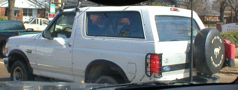 1983 Ford Bronco - This 1983 Ford Bronco is parked on a street with another vehicle in the background.