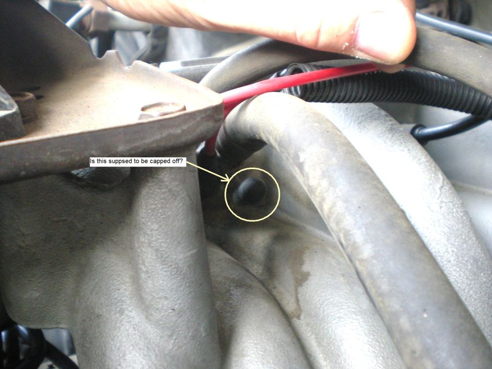 Close-up of uncapped engine port on a 1990 Ford Bronco intake manifold.