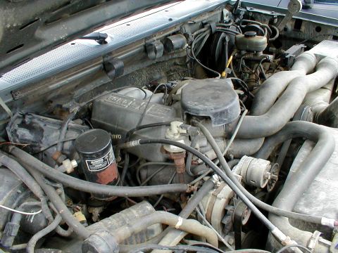 1983 Ford Bronco - Engine bay of a Ford vehicle, showing V8 engine components and associated plumbing.
