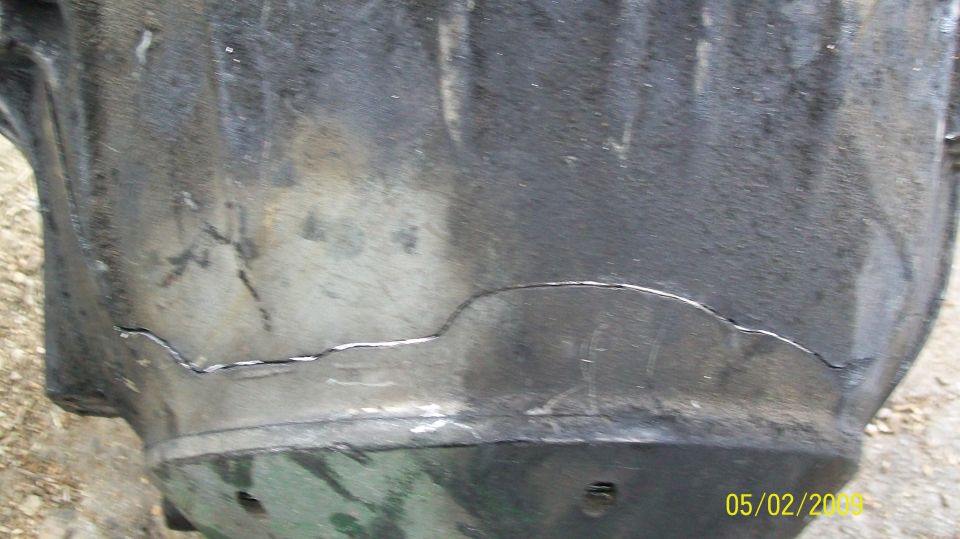 Cracked metal housing, possibly from a vehicle drivetrain.