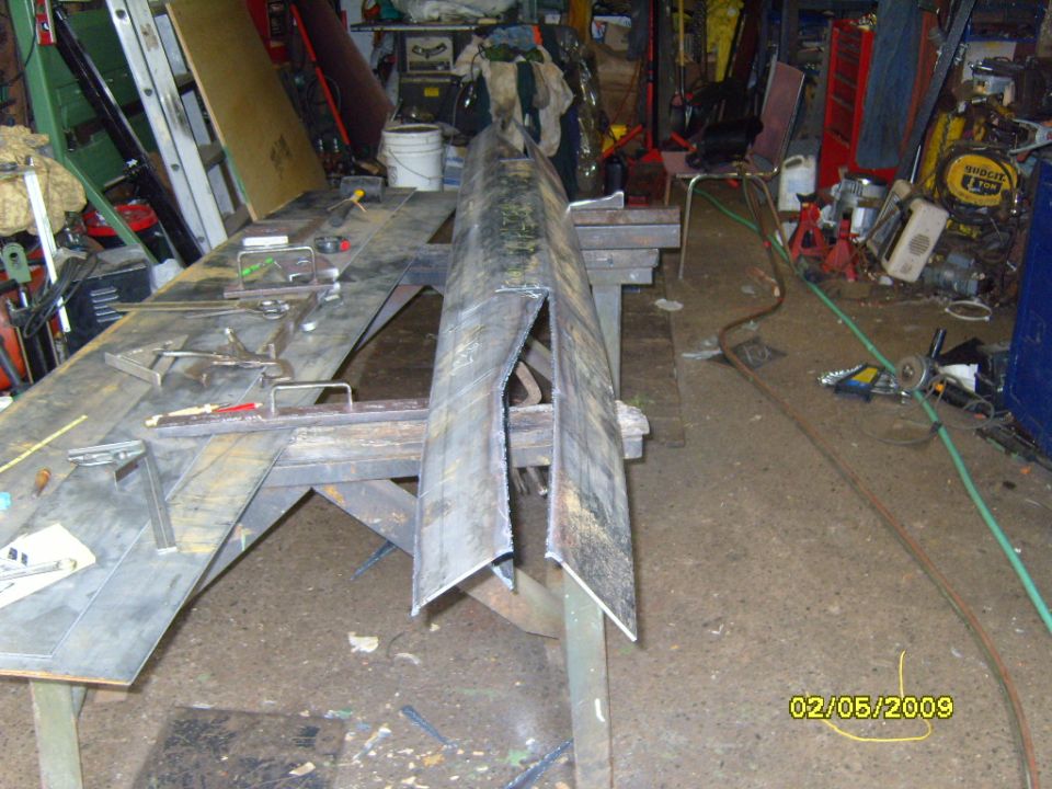 Metal fabrication project in a workshop with tools and materials.