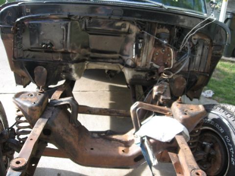 1966 Ford F-100 - Close-up view of the undercarriage of a vehicle, showing frame and suspension parts.