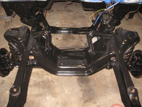 1966 Ford F-100 - Front suspension and frame assembly of a truck, recently painted black.