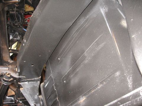 1966 Ford F-100 - Close-up view of the undercarriage, focusing on the wheel well area and structural components.