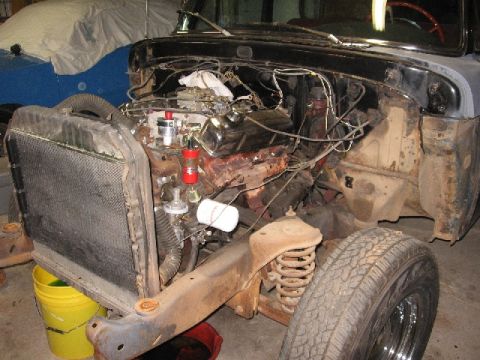 1966 Ford F-100 - Front end of a 1966 Ford F-100 undergoing engine work, with the radiator detached.