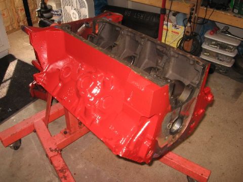 1966 Ford F-100 - A red engine block is mounted on a red engine stand, likely for rebuild or detail work.