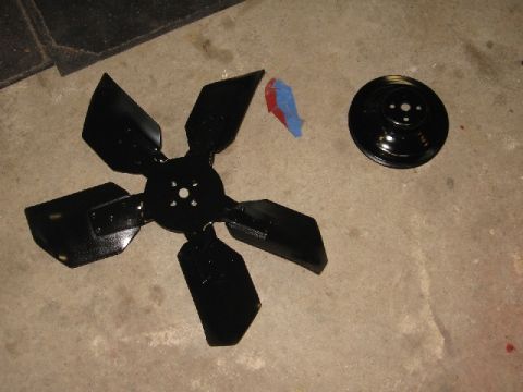 1966 Ford F-100 - Engine fan and pulley components laid out on a concrete surface.