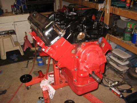 1966 Ford F-100 - A freshly painted engine sits on an engine stand in a workshop, ready for installation or further work.