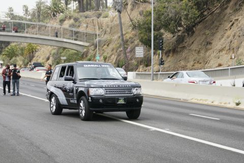 1993 Ford Taurus - A black Range Rover with Gumball 3000 decals is seen on the highway.