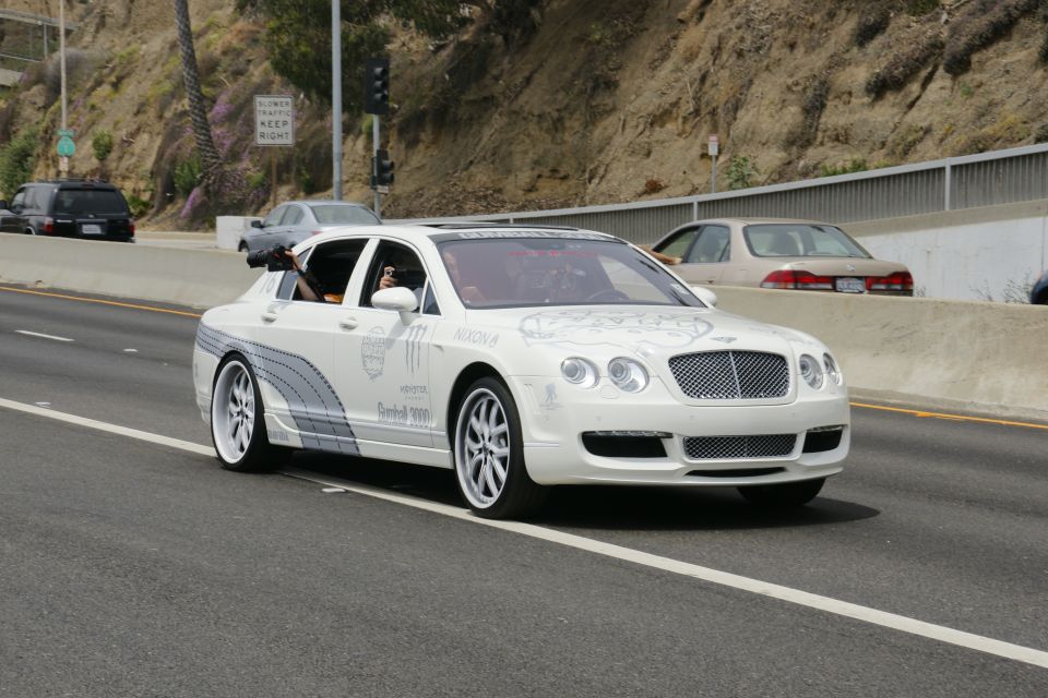 White Bentley Continental Flying Spur with Monster Energy graphics on highway