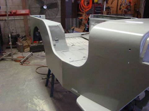 1948 Jeep Wrangler - 1948 Jeep Wrangler tub undergoing restoration in a garage setting.