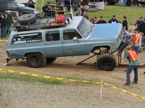 1990 Chevrolet Suburban - Modified 1990 Chevrolet Suburban on display, equipped with off-road tires and a roof-mounted cargo rack.