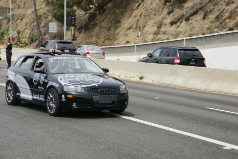 1993 Ford Taurus - This black Audi A3 hatchback is seen on the highway with Gumball 3000 decals and racing stripes.