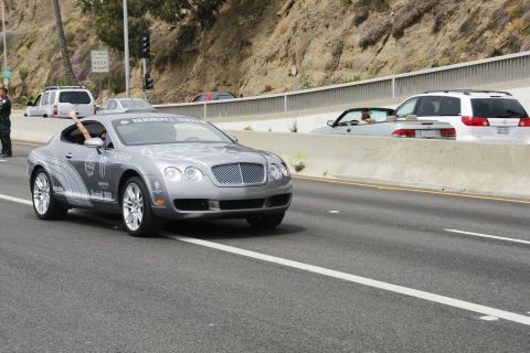 1993 Ford Taurus - A Bentley Continental GT with Gumball 3000 decals is seen on the highway.