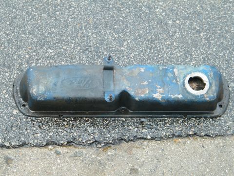 1982 Ford Bronco - A blue Ford valve cover with the "Ford" logo is shown on an asphalt surface.