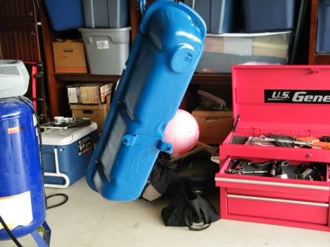 1982 Ford Bronco - A blue Ford oil pan is displayed in a garage setting next to a red toolbox and air compressor.