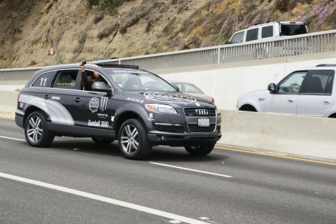 1993 Ford Taurus - An Audi Q7 with racing decals is seen on the highway, with another vehicle in the background.