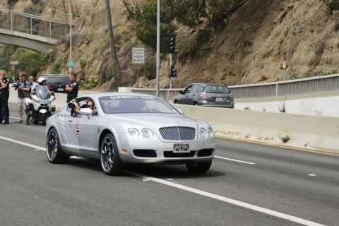 1993 Ford Taurus - A silver Bentley Continental GT participates in the Gumball 3000 rally, escorted by law enforcement.