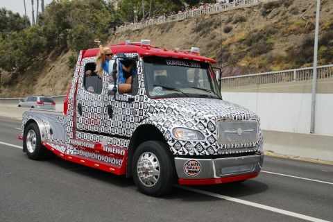 1993 Ford Taurus - A custom-decorated truck participates in the Gumball 3000 rally, with a passenger waving from the cab.