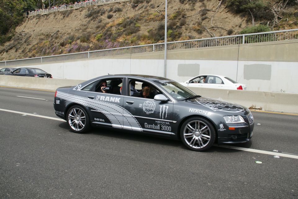 Dark sedan with Gumball 3000 decals, including Monster Energy and Nixon logos