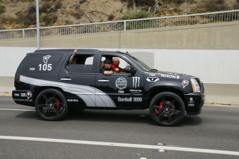 1993 Ford Taurus - This black Cadillac Escalade is decorated with Gumball 3000 branding and racing numbers.