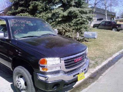 2001 Ford F-350 - A black GMC pickup truck is parked in front of a house with a mailbox numbered 2805.