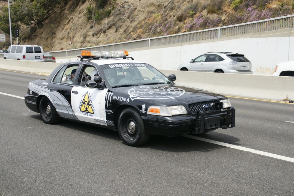 Police car with 'Gumball 3000' and 'Team Wu' graphics, plus Monster Energy and Nixon logos