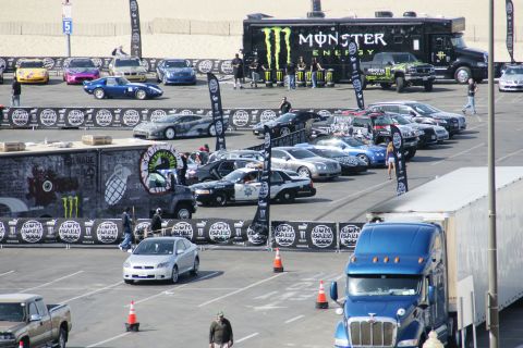 1993 Ford Taurus - A variety of vehicles are gathered in a parking lot, including a police car and a Monster Energy truck.