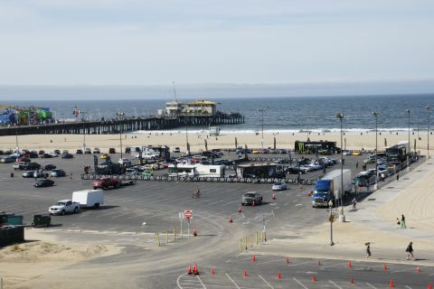 1993 Ford Taurus - A wide view of a parking lot filled with vehicles, with a pier and the ocean in the background.