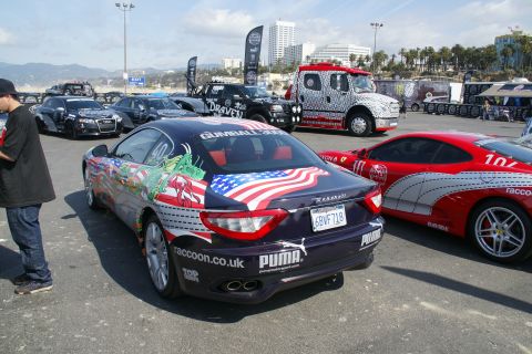 1993 Ford Taurus - Maserati GranTurismo with custom livery and a red Ferrari in the background at an event.