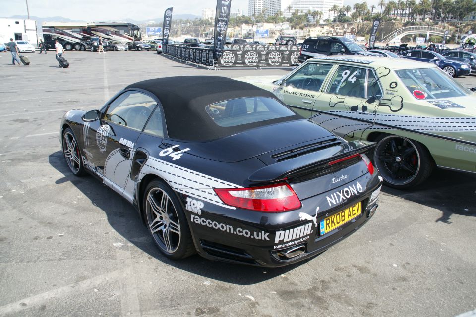 Black convertible sports car with white racing stripes and Puma decals