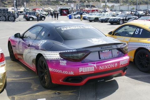 1993 Ford Taurus - Maserati GranTurismo with racing livery and sponsor decals, parked at an event.