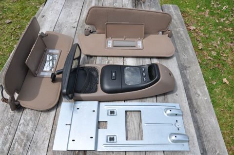 1996 Ford Bronco - Photo of removed interior parts including sun visors and an overhead console, not a technical document.