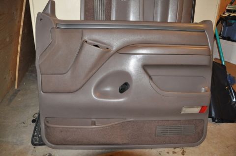 1996 Ford Bronco - Photo of a removed interior door panel, not a technical document.
