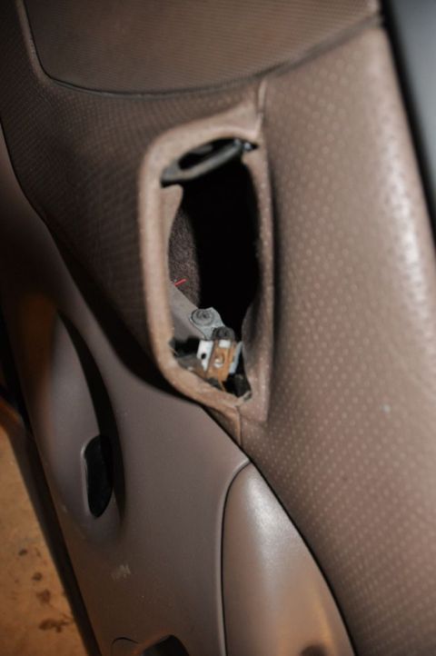 1996 Ford Bronco - Photo of a door panel detail showing an internal latch, not a technical document.