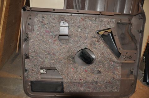 1996 Ford Bronco - Photo of the rear of a door panel with sound insulation, not a technical document.