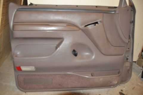1996 Ford Bronco - Interior door panel from a Ford Bronco, likely from the driver's side.