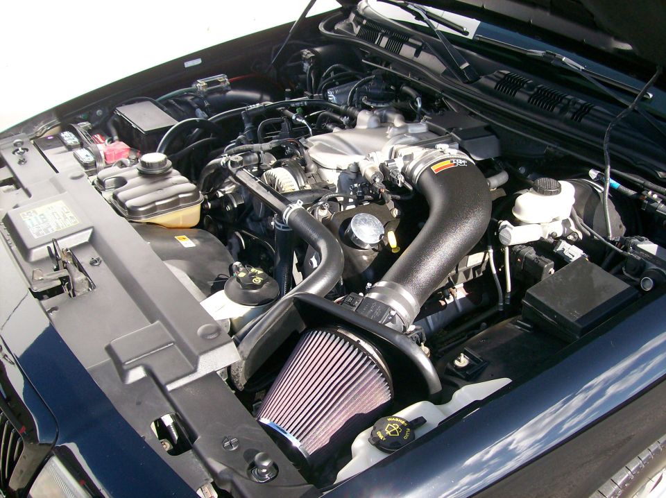 Engine bay of a black Mercury Marauder with K&N cold air intake