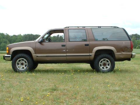 1994 GMC Suburban - Just a small lift to clear the tires. Torsion bar tweak up front, 2" blocks and Monroe Sensatrac Load-adjust shocks in the rear.