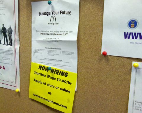 2006 Ford E350 - A hiring poster for McDonald's is pinned to a corkboard. The poster advertises a hiring day on Thursday, September 27th, with a starting wa…