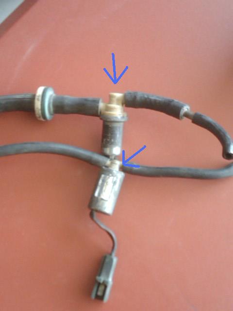 1982 Ford Bronco - Close-up view of a faucet assembly with attached hoses.