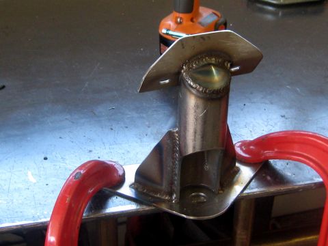 1996 Ford Bronco - A custom metal bracket is shown clamped to a workbench, ready for further work.