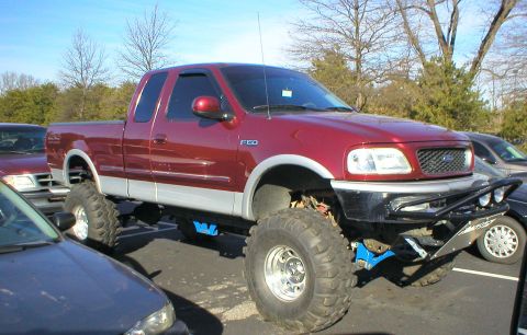1983 Ford Bronco - This lifted 1997 Ford F-150 pickup truck has a custom front bumper and large off-road tires.