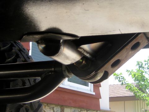 1996 Ford Bronco - Detail of a vehicle's front suspension system, showing a fabricated bracket and linkage.