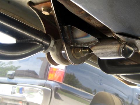 1996 Ford Bronco - Custom suspension components are visible, with a dark SUV in the background.