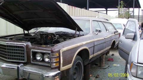 1972 Ford Ranchero - Junkyard scene with a 1975 Ford station wagon, hood up, and other cars around.