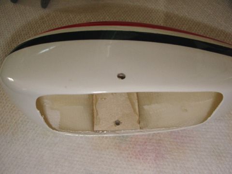2003 Ford Crown Victoria - Close-up of a model airplane fuselage part, showing construction details and painted stripes.